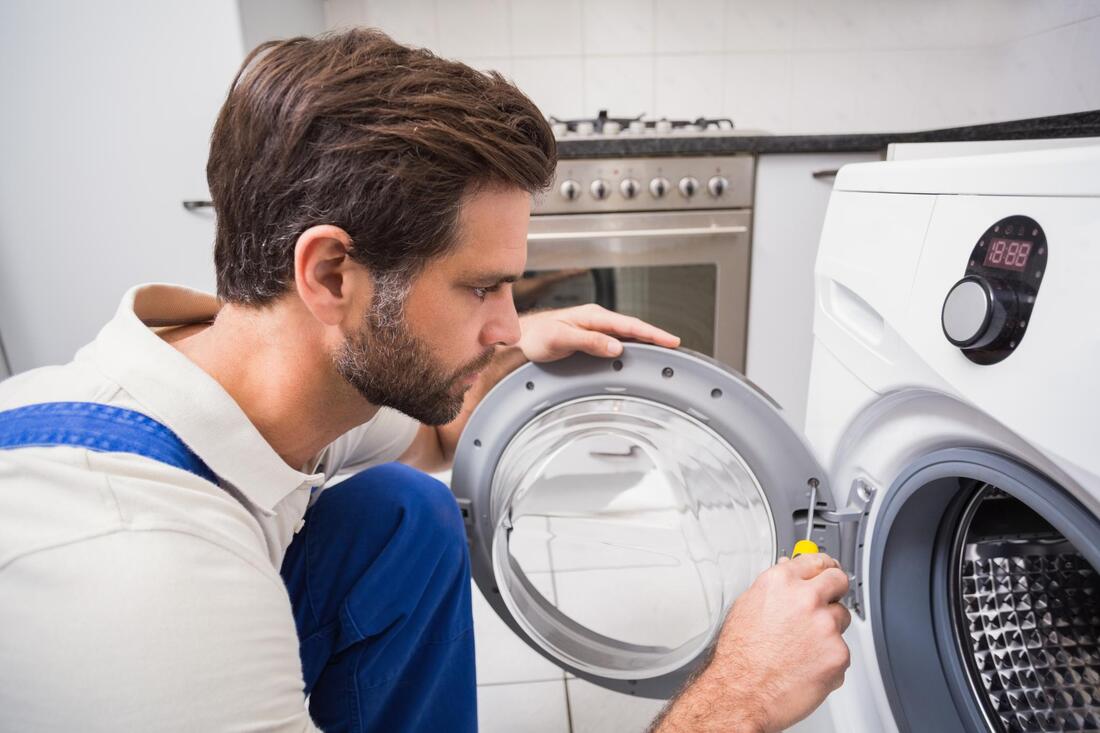 man fixing a dryer
